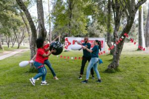 Four young people playing in a park, depicting how culture affects Your nonprofit success